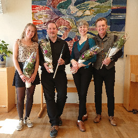 Muintir the band, holding flowers after a performance